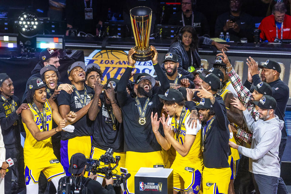 The Los Angeles Lakers' LeBron James holds up the winning trophy along with teammates after defeating the Indiana Pacers in their NBA in-season tournament championship game at T-Mobile Arena on Dec. 9, 2023, in Las Vegas. (L.E. Baskow/Las Vegas Review-Journal/Tribune News Service via Getty Images)