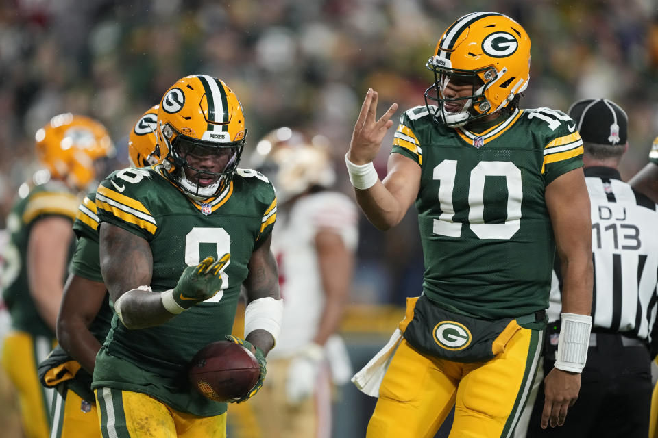 GREEN BAY, WISCONSIN - NOVEMBER 24: Josh Jacobs #8 and Jordan Love #10 of the Green Bay Packers celebrate after scoring a touchdown in the fourth quarter against the San Francisco 49ers at Lambeau Field on November 24, 2024 in Green Bay, Wisconsin. (Photo by Patrick McDermott/Getty Images)