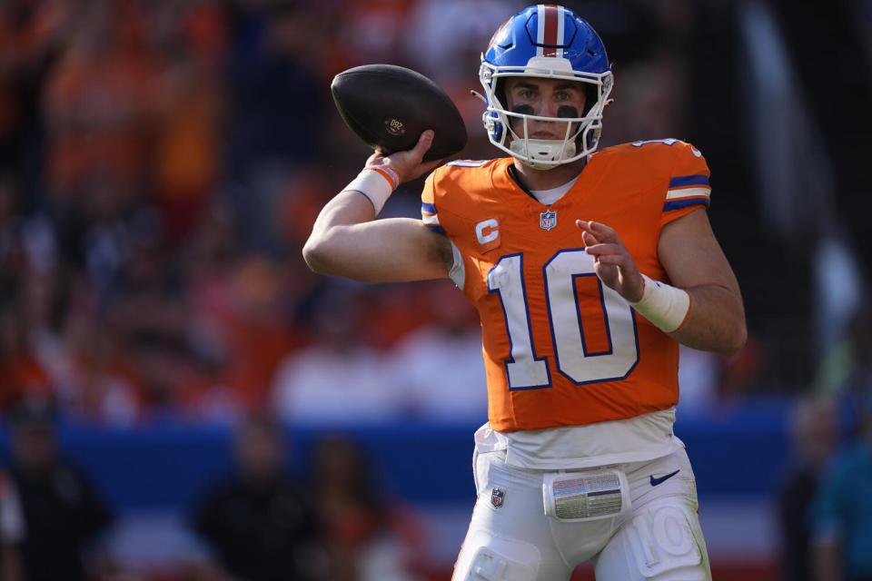 Denver Broncos quarterback Bo Nix (10) sets to throw the football.