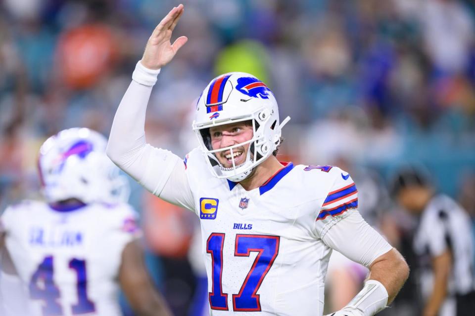 Buffalo Bills quarterback Josh Allen (17), with a big smile on his face, celebrates a touchdown