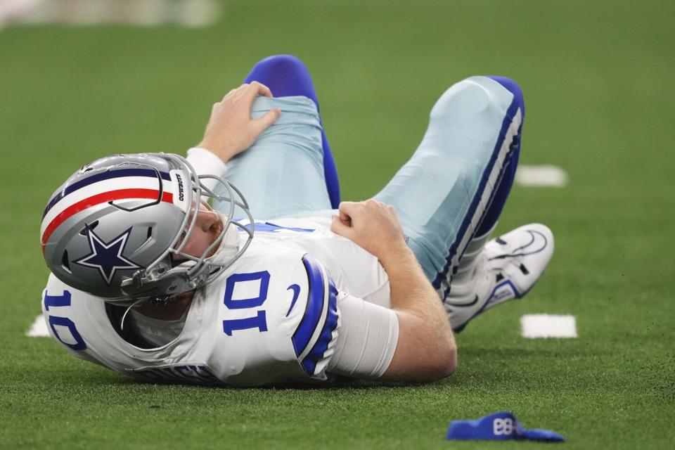 Cowboys quarterback Cooper Rush (10) looks for the football after fumbling against the Eagles.