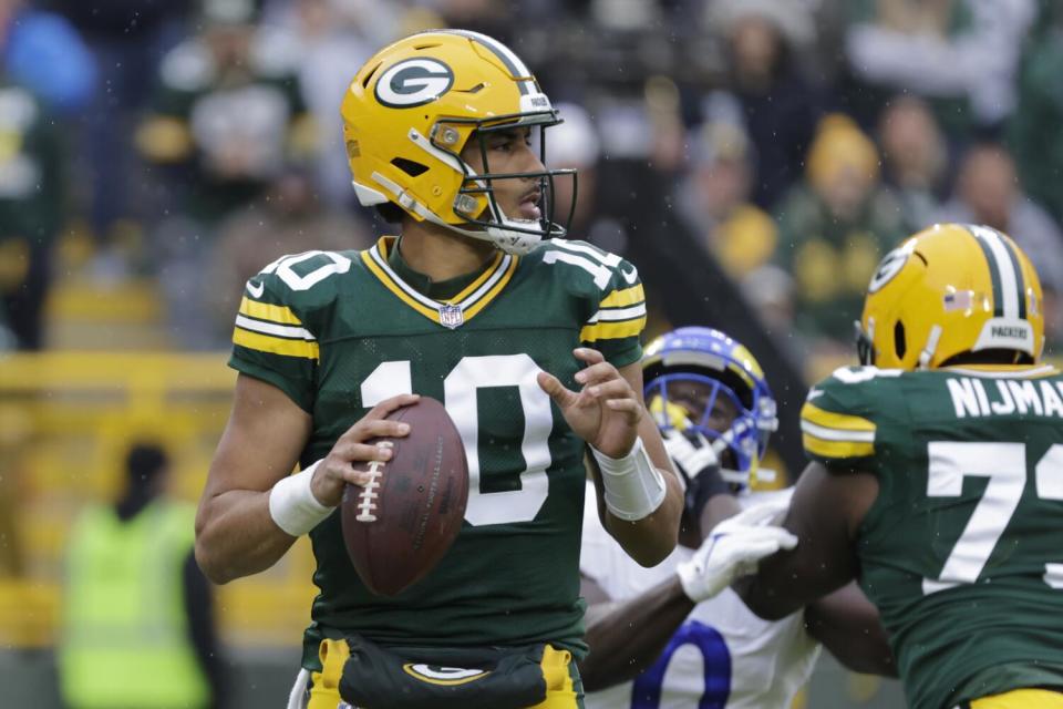 Green Bay Packers quarterback Jordan Love (10) looks to pass against the Rams.