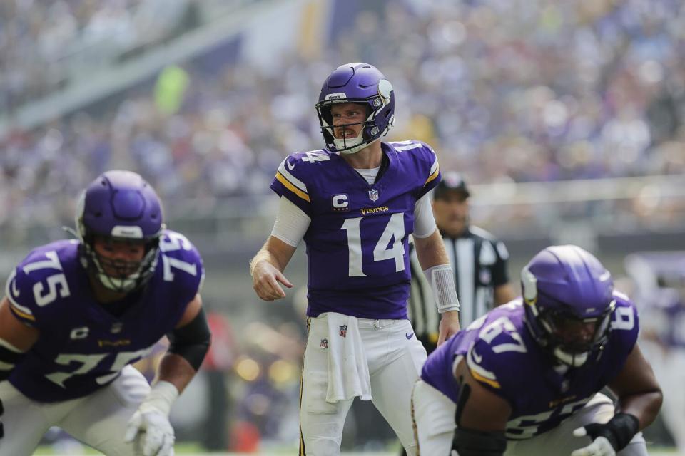 Minnesota Vikings quarterback Sam Darnold (14) calls out a play at the line of scrimmage.