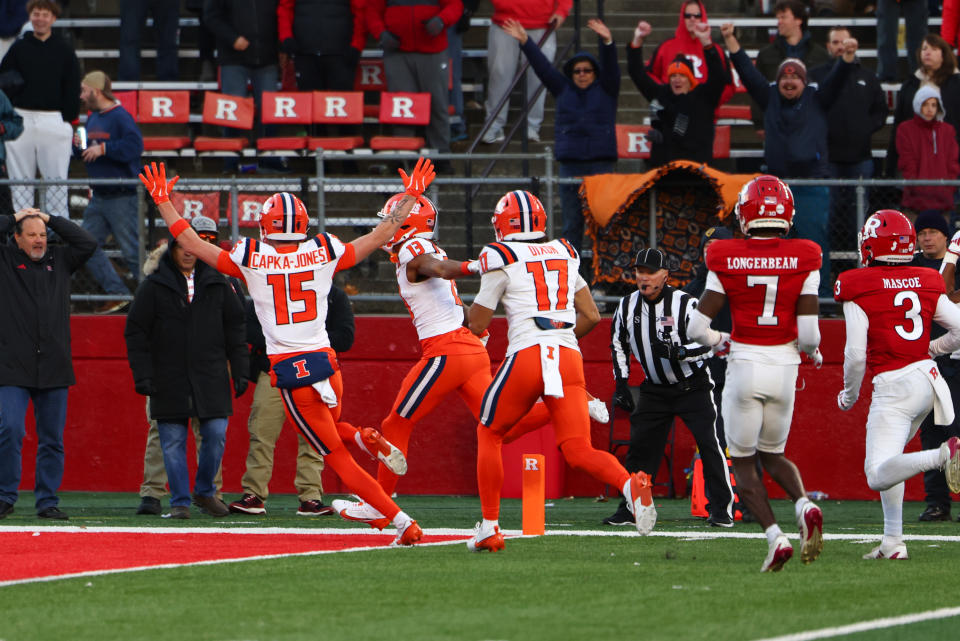 PISCATAWAY, NEW JERSEY - NOVEMBER 23: Pat Bryant #13 of the Illinois Fighting Illini scores a touchdown during the fourth quarter of their game against the Rutgers Scarlet Knights at SHI Stadium on November 23, 2024 in Piscataway, New Jersey. (Photo by Ed Mulholland/Getty Images)