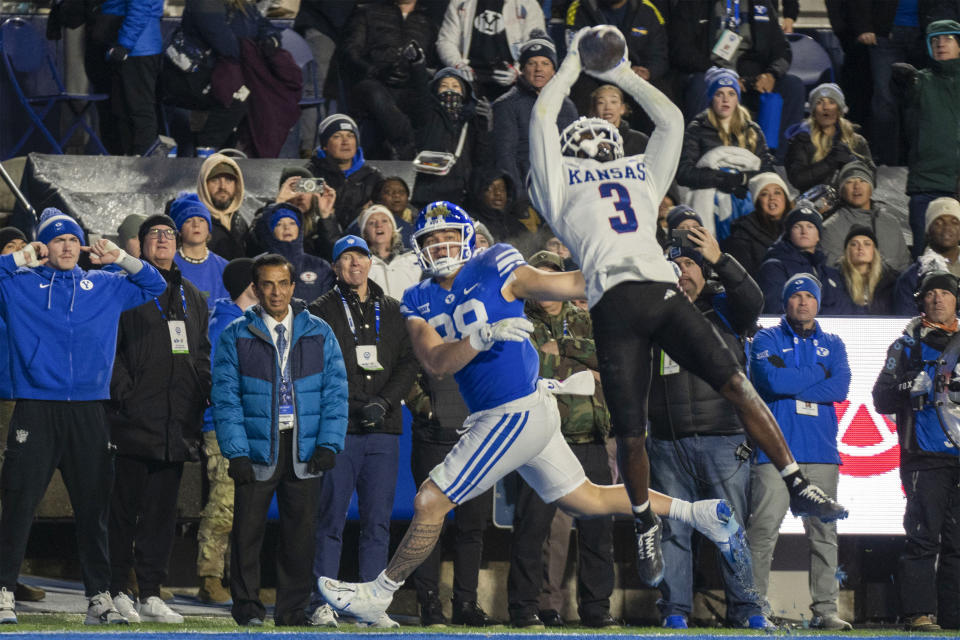 Kansas cornerback Mello Dotson (3) intercepts a pass in the endzone as BYU tight end Mata'ava Ta'ase (88) defends during the first half of an NCAA college football game Saturday, Nov. 16, 2024, in Provo. (AP Photo/Rick Egan)