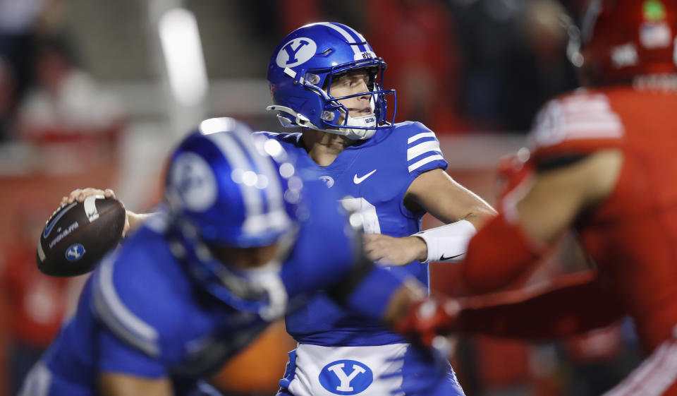 SALT LAKE CITY, UT - NOVEMBER 9: Jake Retzlaff #12 of the Brigham Young Cougars throws a pass under pressure from the Utah Utes during the first half of their game at Rice-Eccles Stadium on November 9, 2024 in Salt Lake City, Utah.(Photo by Chris Gardner/Getty Images)