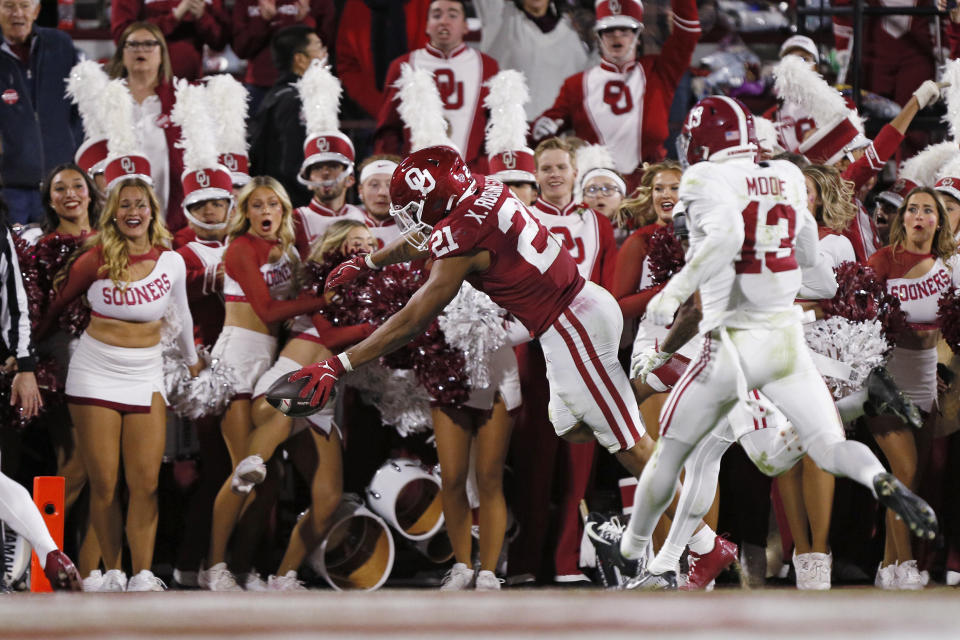 NORMAN, OKLAHOMA - NOVEMBER 23: Running back Xavier Robinson #21 of the Oklahoma Sooners dives for the end zone to score an 18-yard touchdown against the Alabama Crimson Tide in the second quarter at Gaylord Family Oklahoma Memorial Stadium on November 23, 2024 in Norman, Oklahoma. (Photo by Brian Bahr/Getty Images)