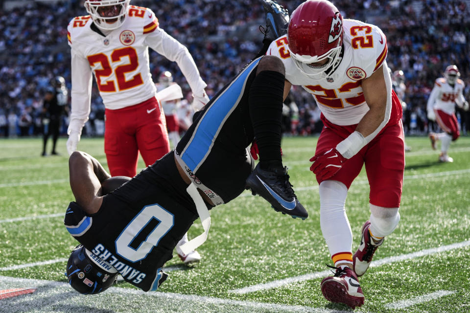 Kansas City Chiefs linebacker Drue Tranquill (23) hits Carolina Panthers tight end Ja'Tavion Sanders (0) during the first half of an NFL football game, Sunday, Nov. 24, 2024, in Charlotte, N.C. Sanders, was taken off the field due to injury after the play. (AP Photo/Rusty Jones)