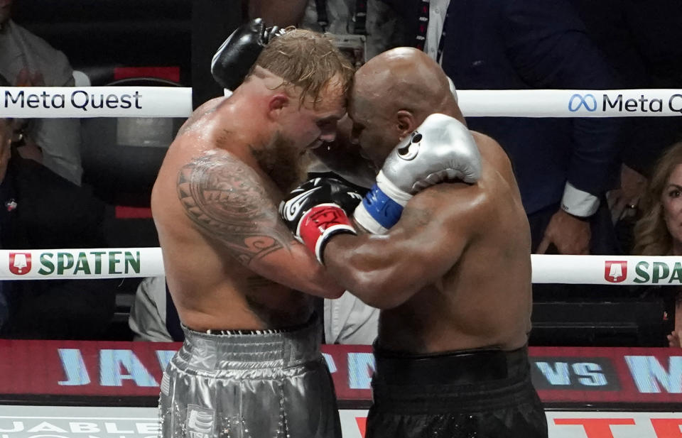 US YouTuber/boxer Jake Paul (L) and US retired pro-boxer Mike Tyson (R) hug at the end of their heavyweight boxing bout at The Pavilion at AT&T Stadium in Arlington, Texas, November 15, 2024. (Photo by TIMOTHY A. CLARY / AFP) (Photo by TIMOTHY A. CLARY/AFP via Getty Images)