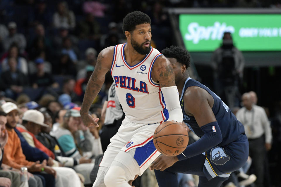 Philadelphia 76ers forward Paul George (8) handles the ball ahead of Memphis Grizzlies forward Jaren Jackson Jr. (13) in the first half of an NBA basketball game Wednesday, Nov. 20, 2024, in Memphis, Tenn. (AP Photo/Brandon Dill)