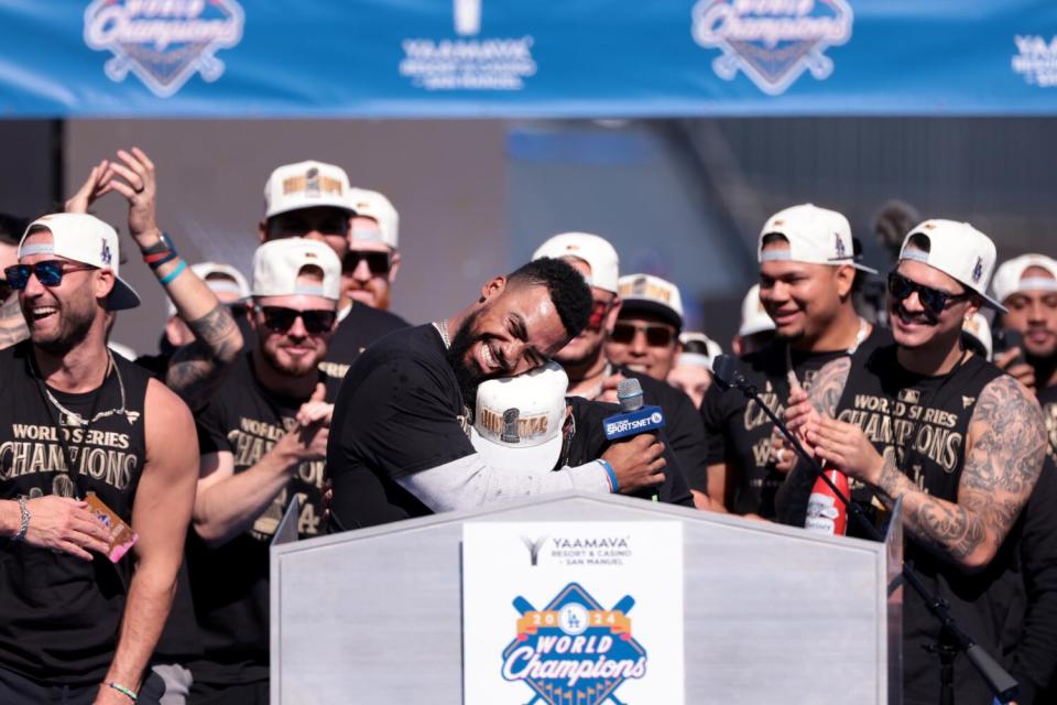 Dodger Teoscar Hernández hugs teammate Mookie Betts during the team's World Series celebration on Nov. 1.