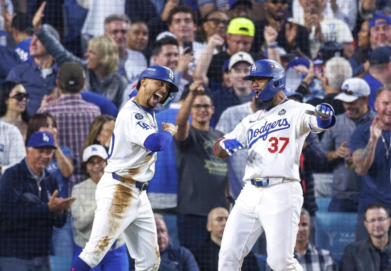 Dodger Teoscar Hernández celebrates with teammate Mookie Betts after hitting a two-run homer during the World Series