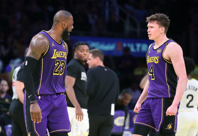 Los Angeles, California November 19, 2024-Lakers LeBron James, left, celebrates Dalton Knecht's three-pointer against the Jazz in the second half at Crypto.com Arena Tuesday. (Wally Skalij/Los Angeles Times)