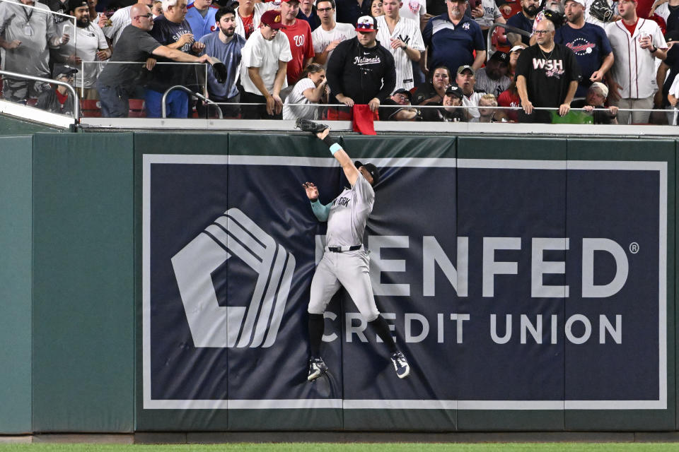 WASHINGTON, DC - AUGUST 26, 2024: Aaron Judge #99 of the New York Yankees leaps up against the outfield wall to catch a fly ball hit by Andres Chaparro of the Washington Nationals during the bottom of the fourth inning of an interleague game at Nationals Park on August 26, 2024 in Washington, DC. The Yankees beat the Nationals, 5-2. (Photo by Diamond Images via Getty Images)