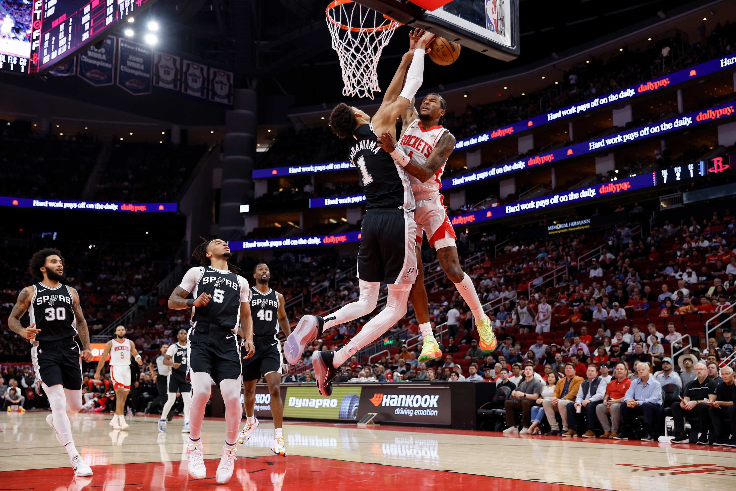 HOUSTON, TEXAS - NOVEMBER 06: Victor Wembanyama #1 of the San Antonio Spurs defends a dunk attempt by Jalen Green #4 of the Houston Rockets in the first half at Toyota Center on November 06, 2024 in Houston, Texas. NOTE TO USER: User expressly acknowledges and agrees that, by downloading and or using this photograph, User is consenting to the terms and conditions of the Getty Images License Agreement. (Photo by Tim Warner/Getty Images)