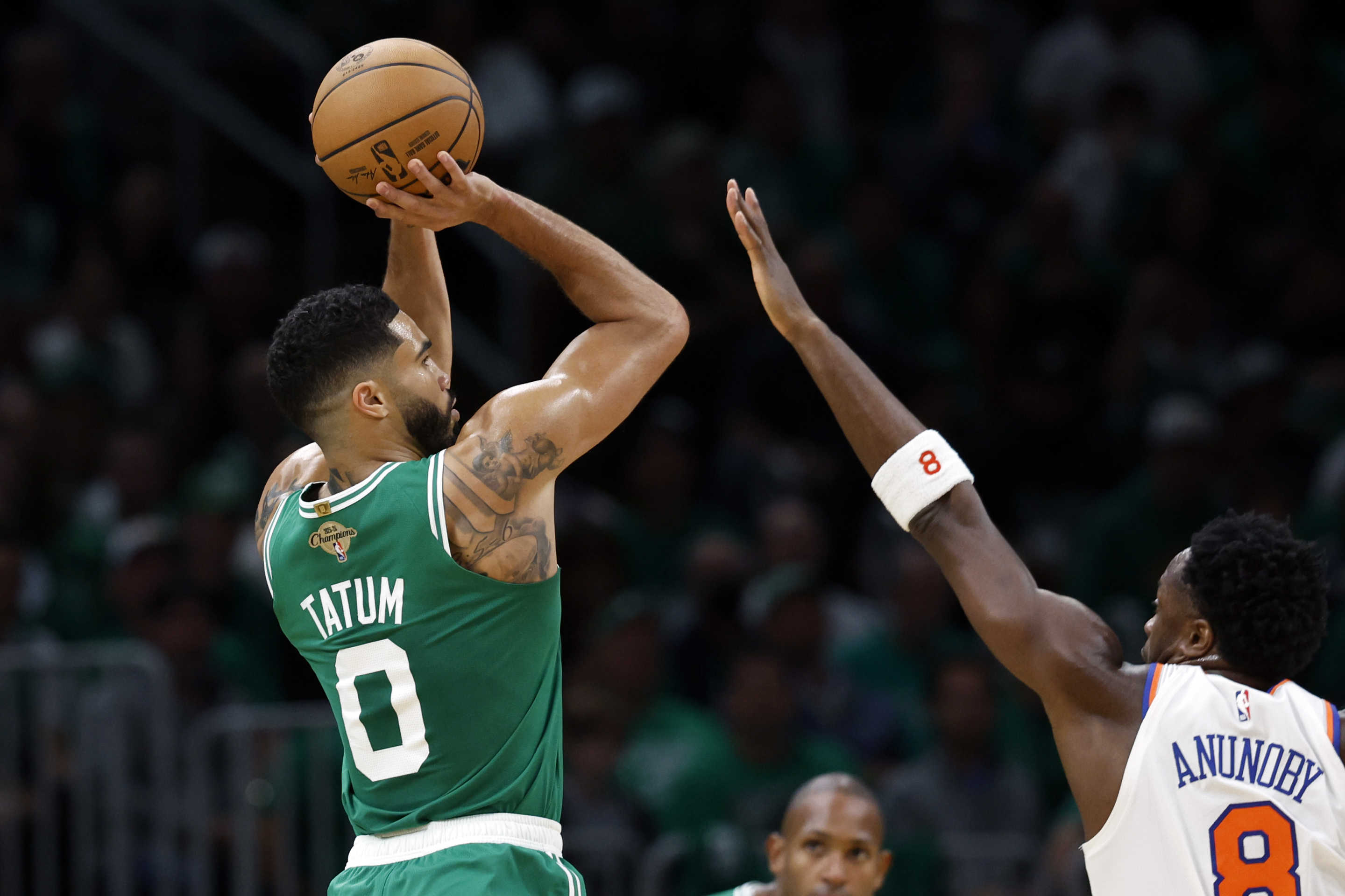 Boston, MA - October 22: Boston Celtics SF Jayson Tatum shoots a 3-point basket with pressure from New York Knicks SF OG Anunoby in the first quarter at TD Garden. (Photo by Danielle Parhizkaran/The Boston Globe via Getty Images)