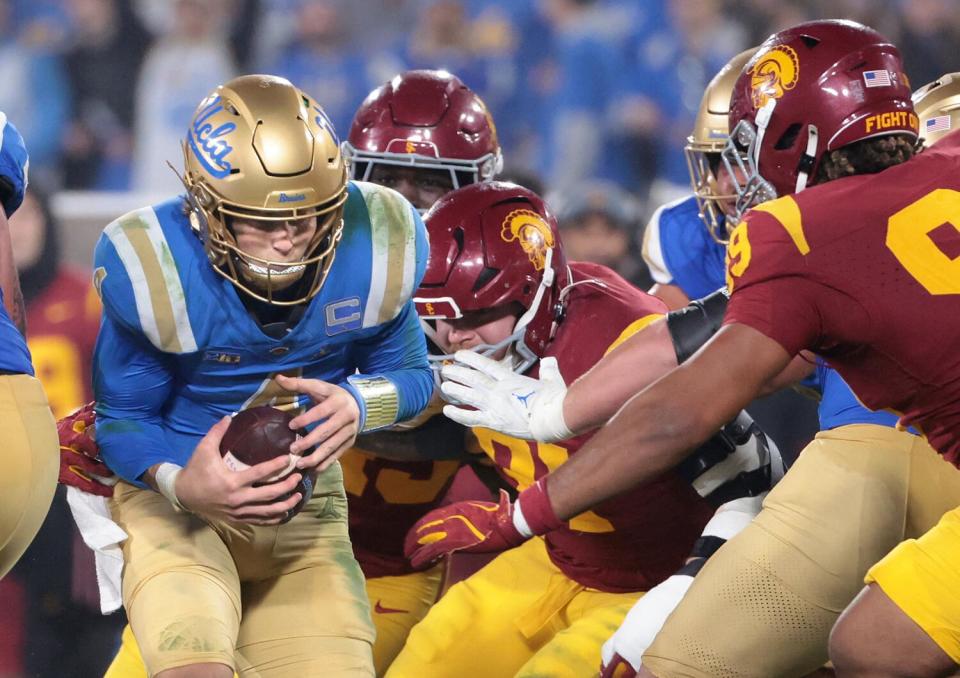 UCLA quarterback Ethan Garbers is sacked by the USC defense in the third quarter Saturday.