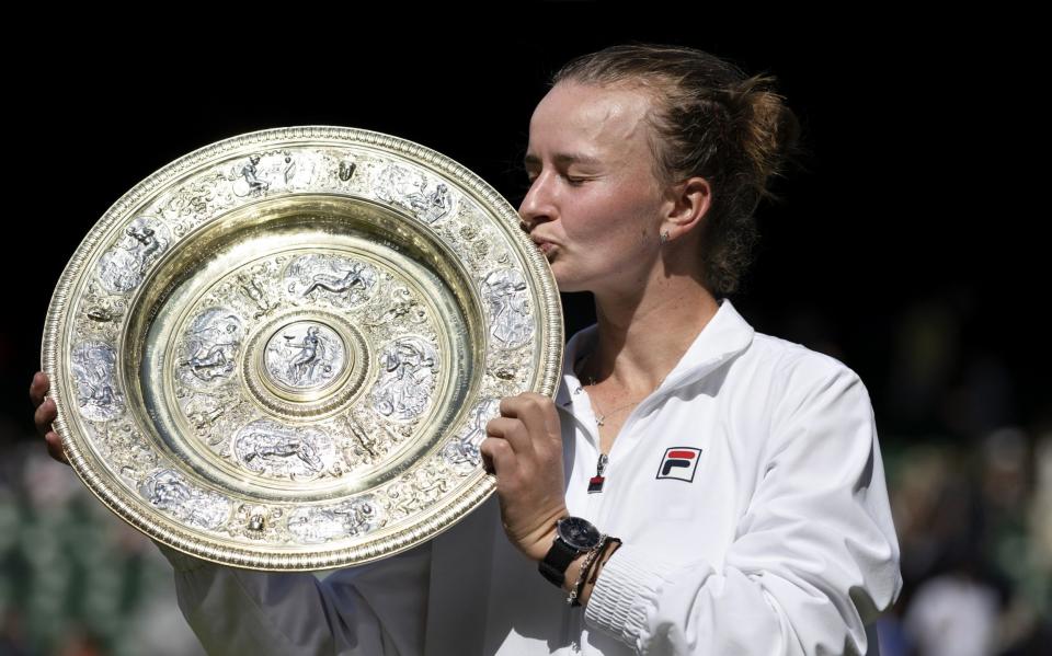 Barbora Krejcikova (CZE) kisses the trophy after winning her Ladies's Singles Final against Jasmine Paolini (ITA) during day thirteen of The Championships Wimbledon