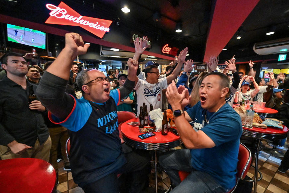 Dodgers fans cheer while watching the World Series in a Tokyo bar. (Richard A. Brook/AFP via Getty Images)