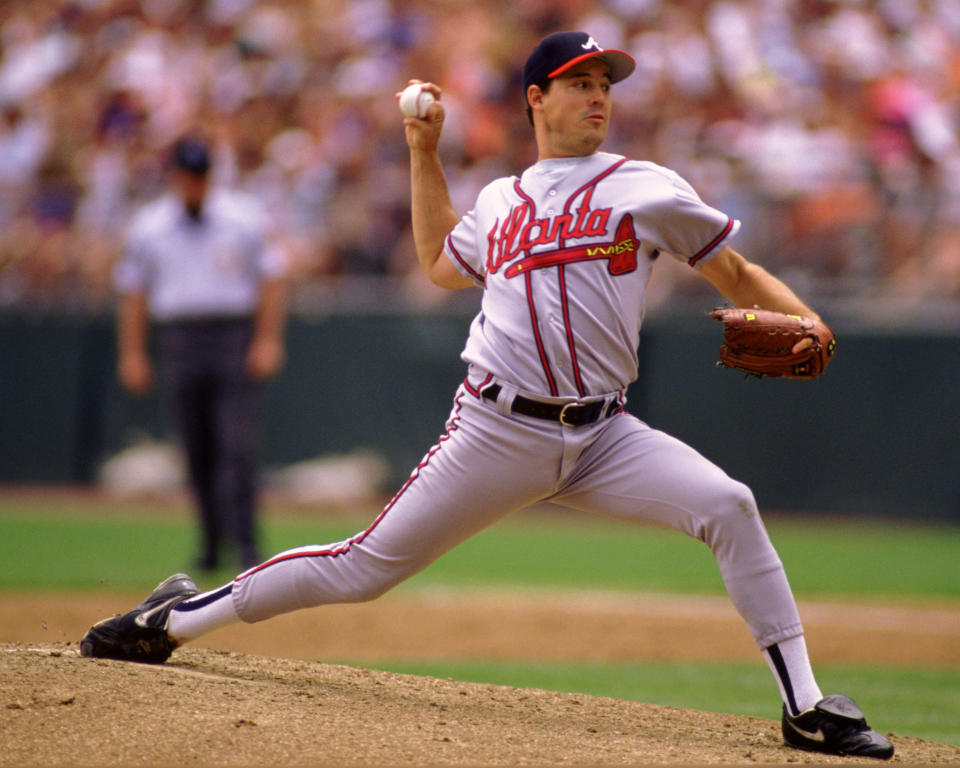 Maddux pitches against the Rockies in 1995. (Ron Vesely/MLB Photos via Getty Images)