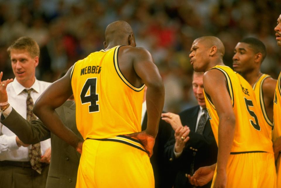 A visibly upset Jalen Rose talks to Chris Webber after his ill-fated timeout call. (John W. McDonough/Sports Illustrated via Getty Images)