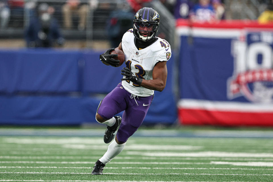 Dec 15, 2024; East Rutherford, New Jersey, USA; Baltimore Ravens running back Justice Hill (43) carries the ball during the second half against the New York Giants at MetLife Stadium. Mandatory Credit: Vincent Carchietta-Imagn Images