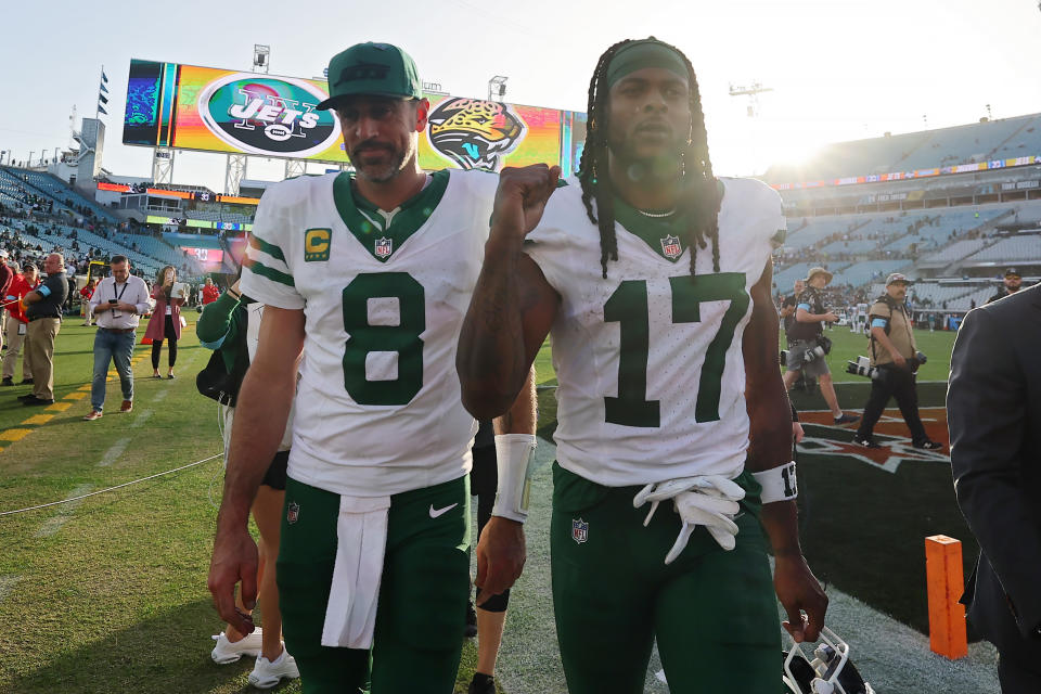 JACKSONVILLE, FLORIDA - DECEMBER 15: Aaron Rodgers #8 and Davante Adams #17 of the New York Jets walk off the field after the game against the Jacksonville Jaguars at EverBank Stadium on December 15, 2024 in Jacksonville, Florida. The Jets defeated the Jaguars 32-25. (Photo by Mike Carlson/Getty Images)