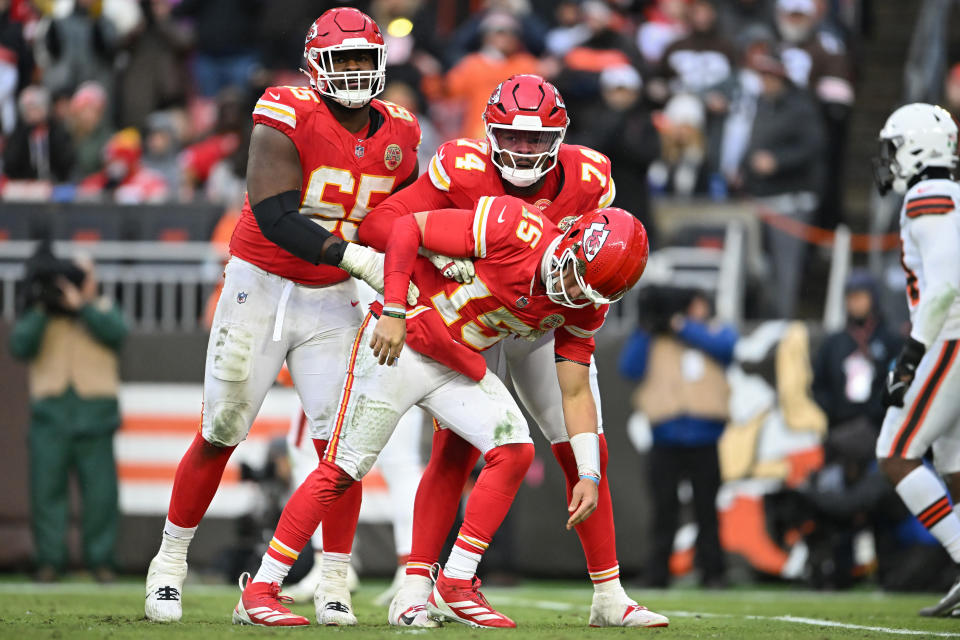 CLEVELAND, OHIO - DECEMBER 15: Trey Smith #65 and Jawaan Taylor #74 of the Kansas City Chiefs help up quarterback Patrick Mahomes #15 after a hit during the third quarter against the Cleveland Browns at Huntington Bank Field on December 15, 2024 in Cleveland, Ohio. (Photo by Nick Cammett/Getty Images)