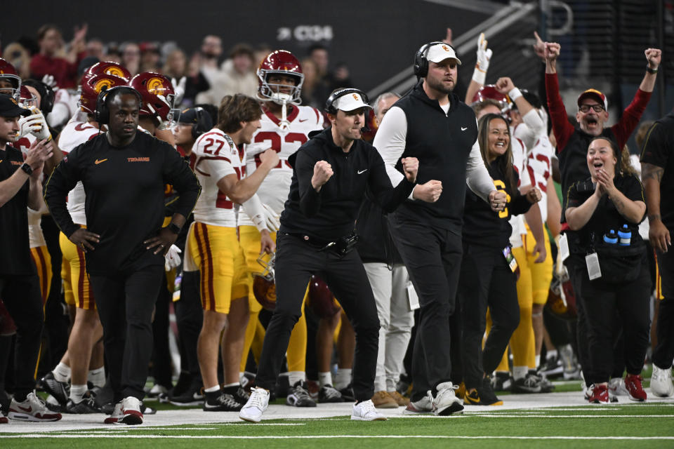 LAS VEGAS, NEVADA - DECEMBER 27: Head coach Lincoln Riley (C) of the USC Trojans reacts after the team scored during the second half against the Texas A&M Aggies in the SRS Distribution Las Vegas Bowl at Allegiant Stadium on December 27, 2024 in Las Vegas, Nevada. The Trojans defeated the Aggies 35-31. (Photo by David Becker/Getty Images)