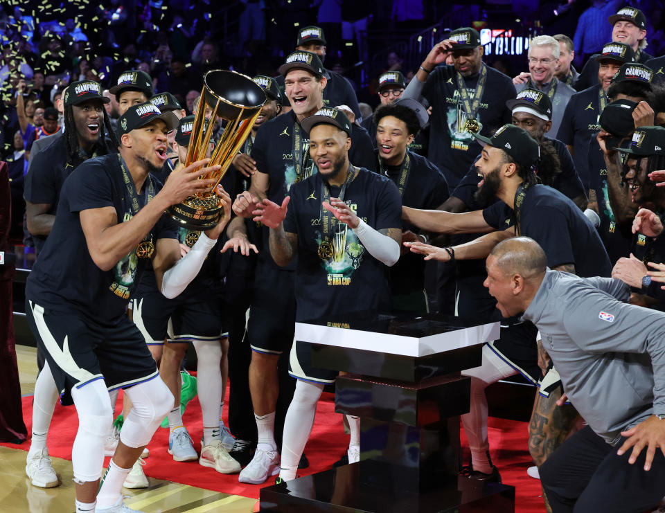 LAS VEGAS, NEVADA - DECEMBER 17: Giannis Antetokounmpo (L) #34 of the Milwaukee Bucks lifts the championship trophy as he celebrates with teammates, including Damian Lillard (C) #0, after the Bucks defeated the Oklahoma City Thunder 97-81 to win the championship game of the Emirates NBA Cup at T-Mobile Arena on December 17, 2024 in Las Vegas, Nevada. NOTE TO USER: User expressly acknowledges and agrees that, by downloading and or using this photograph, User is consenting to the terms and conditions of the Getty Images License Agreement. (Photo by Ethan Miller/Getty Images)