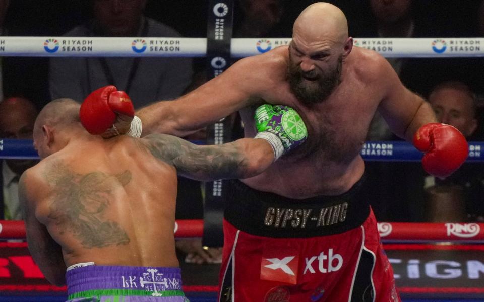 Boxers Britain's Tyson Fury, right, and Ukraine's Oleksandr Usyk compete during their WBA, WBO, and WBC world heavyweight title fight in Riyadh, Saudi Arabia on Saturday.