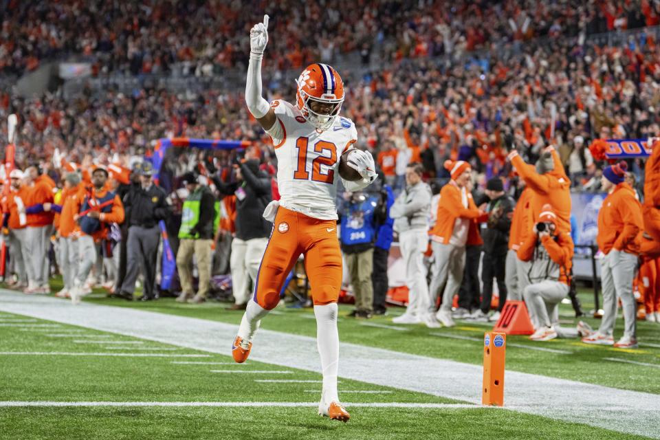 Clemson wide receiver Bryant Wesco Jr. (12) scores a touchdown in the first half of the Atlantic Coast Conference championship NCAA college football game against SMU Saturday, Dec. 7, 2024, in Charlotte, N.C. (AP Photo/Jacob Kupferman)