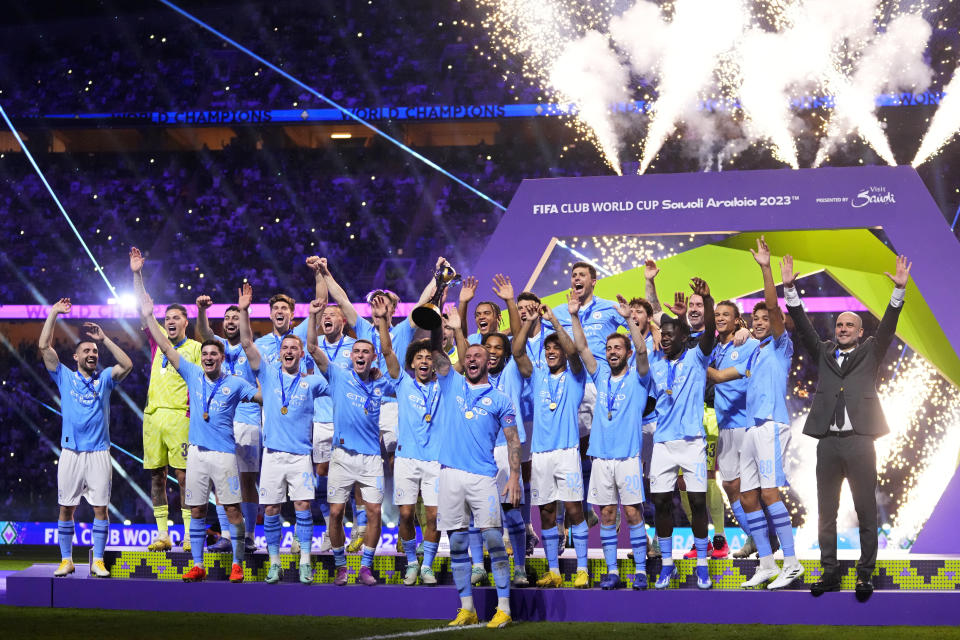 FILE - Manchester City's Kyle Walker, center, lifts the trophy at the end of the Soccer Club World Cup final match between Manchester City FC and Fluminense FC at King Abdullah Sports City Stadium in Jeddah, Saudi Arabia, Dec. 22, 2023. (AP Photo/Manu Fernandez, file)