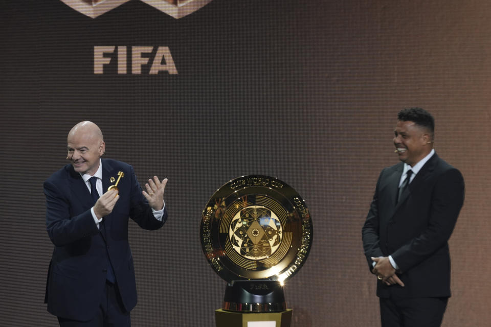 FIFA President Gianni Infantino' and Former professional Brazilian soccer player Ronaldo present a new trophy during the draw for the 2025 FIFA Club World Cup soccer tournament, Thursday, Dec. 5, 2024, in Miami. (AP Photo/Rebecca Blackwell)