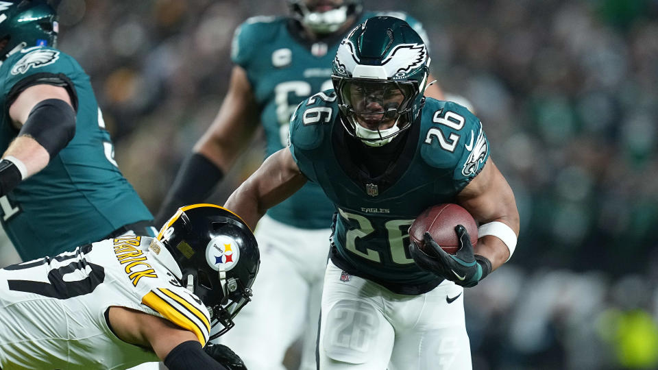 PHILADELPHIA, PENNSYLVANIA - DECEMBER 15: Saquon Barkley #26 of the Philadelphia Eagles runs the ball against Minkah Fitzpatrick #39 of the Pittsburgh Steelers during the first quarter at Lincoln Financial Field on December 15, 2024 in Philadelphia, Pennsylvania. (Photo by Mitchell Leff/Getty Images)