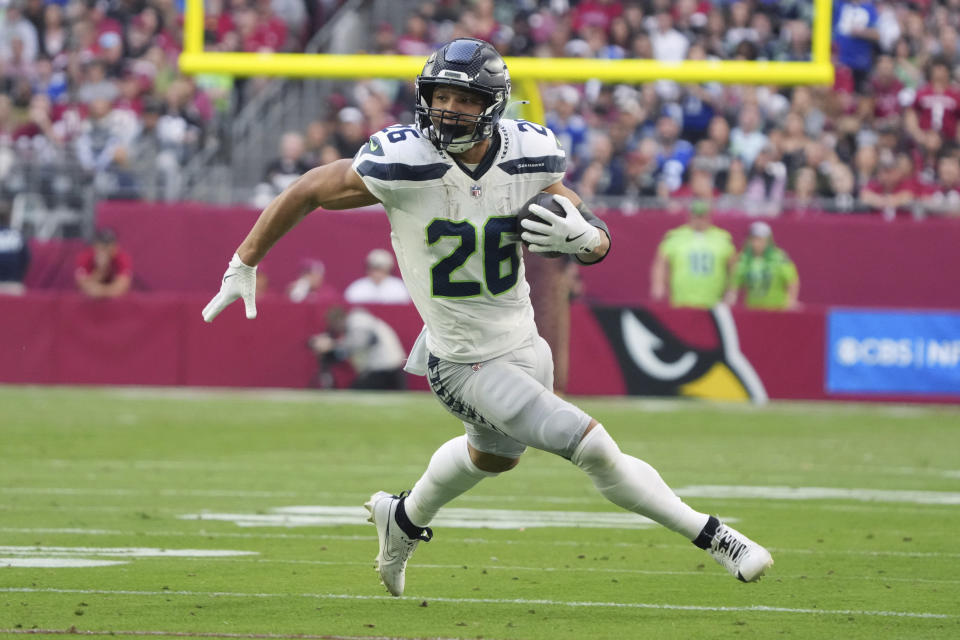 Seattle Seahawks running back Zach Charbonnet (26) runs the ball against the Arizona Cardinals during the first half of an NFL football game, Sunday, Dec. 8, 2024, in Glendale, Ariz. (AP Photo/Rick Scuteri)