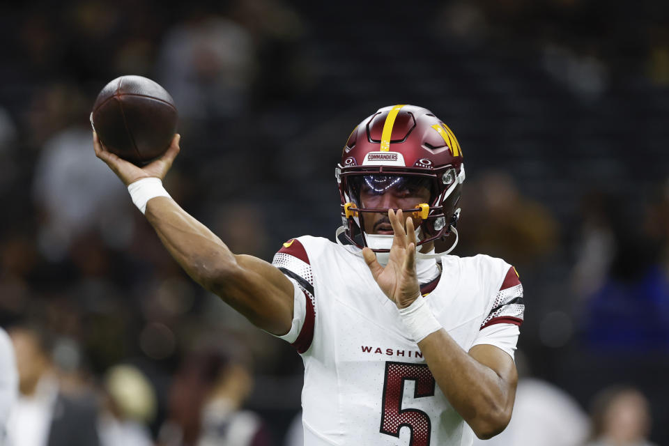 Washington Commanders quarterback Jayden Daniels (5) warms up before an NFL football game against the New Orleans Saints in New Orleans, Sunday, Dec. 15, 2024. (AP Photo/Butch Dill)