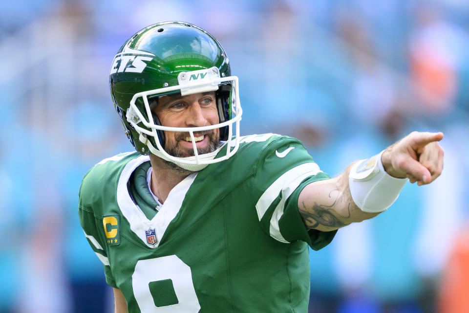 New York Jets quarterback Aaron Rodgers (8) smiles and points during an NFL football game against the Miami Dolphins, Sunday, Dec. 8, 2024, in Miami Gardens, Fla. (AP Photo/Doug Murray)