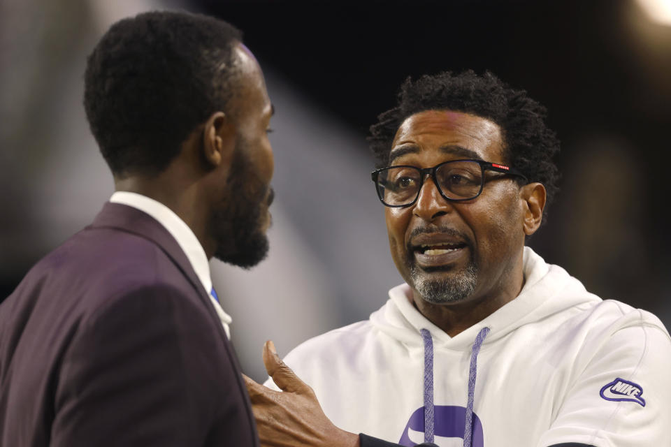 Former Vikings wide receiver Cris Carter, right, talks to Vikings general manager Kwesi Adofo-Mensah, left, before Monday night's game against the Bears. (AP Photo/Bruce Kluckhohn)