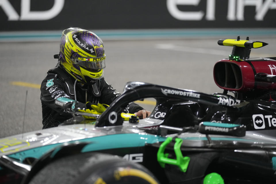 Lewis Hamilton of Britain kneels next to his car after his last race for the Mercedes team after the Formula One Abu Dhabi Grand Prix at the Yas Marina Circuit in Abu Dhabi, UAE, Sunday, Dec. 8, 2024. (AP Photo/Darko Bandic)