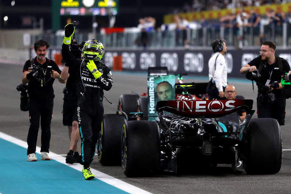 ABU DHABI, UNITED ARAB EMIRATES - DECEMBER 08: 4th placed Lewis Hamilton of Great Britain and Mercedes waves to the crowd after performing donuts on track for his final race with Mercedes during the F1 Grand Prix of Abu Dhabi at Yas Marina Circuit on December 08, 2024 in Abu Dhabi, United Arab Emirates. (Photo by Joe Portlock/Getty Images)