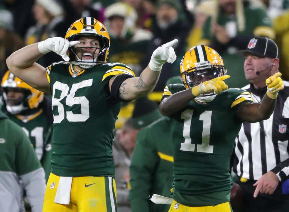 Dec 23, 2024; Green Bay, Wisconsin, USA; Green Bay Packers wide receiver Jayden Reed (11) reacts with tight end Tucker Kraft (85) after cathing a first down pass against the New Orleans Saints at Lambeau Field. Mandatory Credit: Wm. Glasheen USA TODAY NETWORK-Wisconsin/Imagn Images