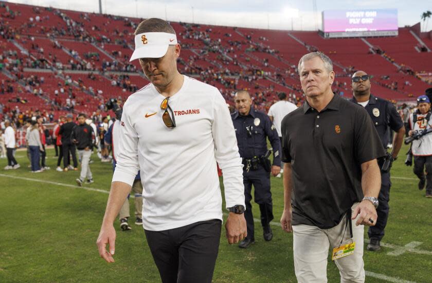 USC coach Lincoln Riley looks down and leaves the field after the Trojans 49-35 loss to Notre Dame Saturday