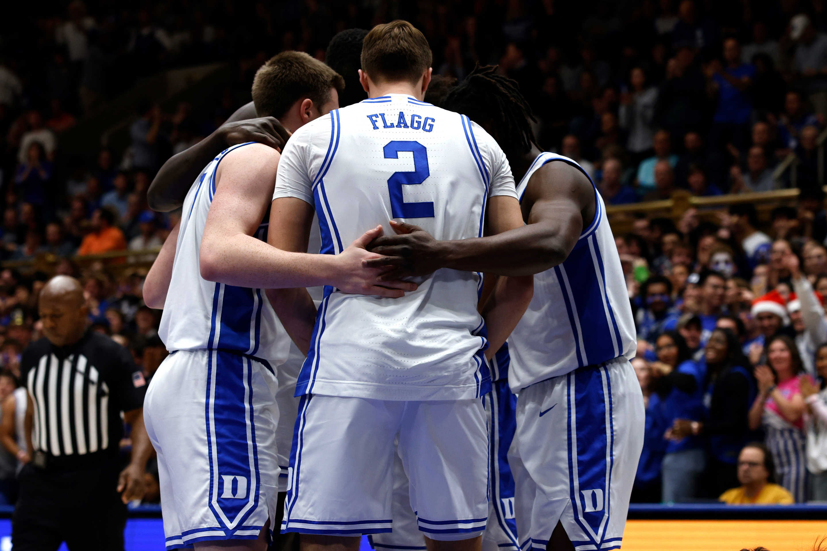 DURHAM, NORTH CAROLINA - DECEMBER 4: Kon Knueppel #7, Cooper Flagg #2, and Sion James #14 of the Duke Blue Devils huddle with teammates during the game against the Auburn Tigers at Cameron Indoor Stadium on December 4, 2024 in Durham, North Carolina. (Photo by Lance King/Getty Images)