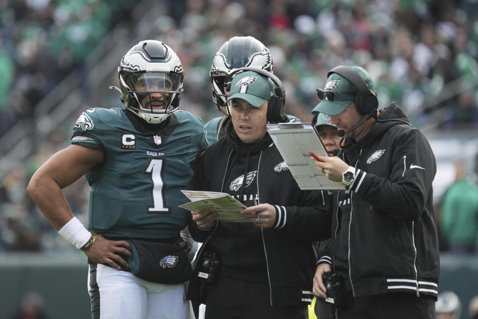 PHILADELPHIA, PA - DECEMBER 08: Philadelphia Eagles quarterback Jalen Hurts (1) confers with Philadelphia Eagles offensive coordinator Kellen Moore during the game between the Philadelphia Eagles and the Carolina Panthers on December 08, 2024 at Lincoln Financial Field in Philadelphia, PA. (Photo by Andy Lewis/Icon Sportswire via Getty Images)