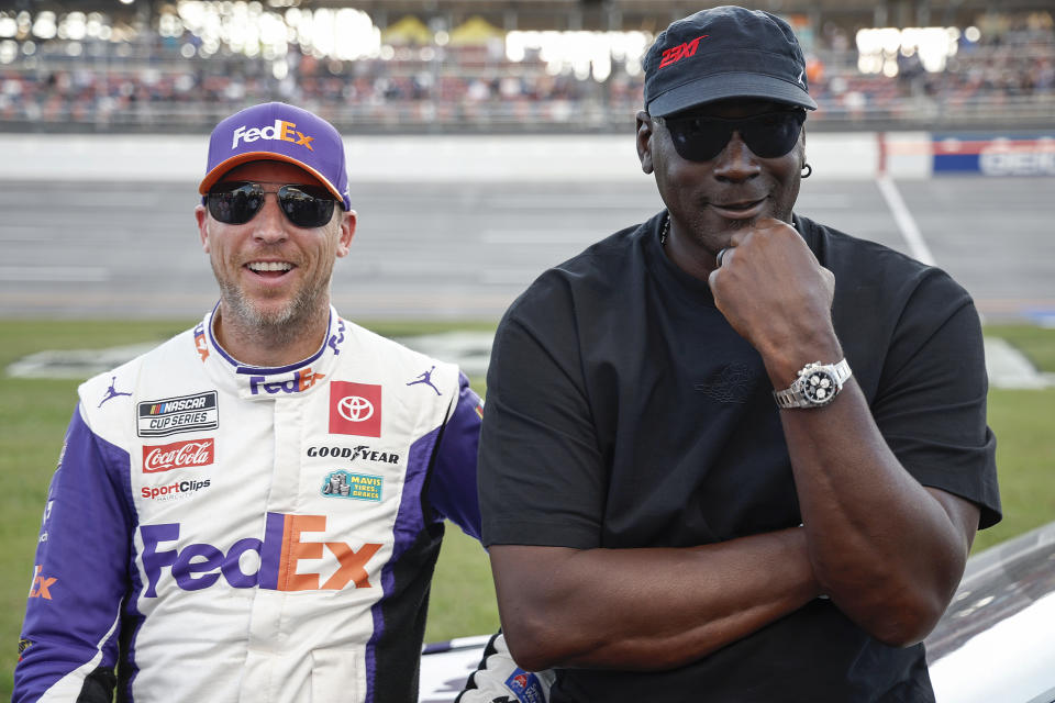 TALLADEGA, ALABAMA - OCTOBER 06: Co-owners of 23XI Racing, Denny Hamlin, driver of the #11 FedEx One Rate Toyota, and NBA Hall of Famer, Michael Jordan talk on the grid after the NASCAR Cup Series YellaWood 500 at Talladega Superspeedway on October 06, 2024 in Talladega, Alabama. (Photo by Chris Graythen/Getty Images)