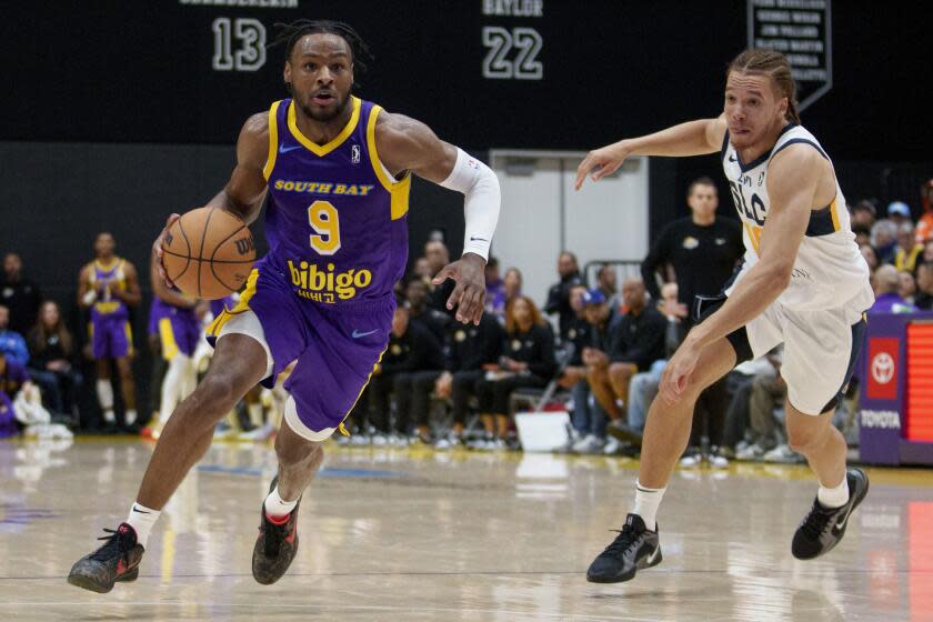 South Bay Lakers guard Bronny James (9) dribbles against Salt Lake City Stars forward Jason Preston, right, during the first half of an NBA G League basketball game Saturday, Nov. 9, 2024, in El Segundo, Calif. (AP Photo/Eric Thayer)