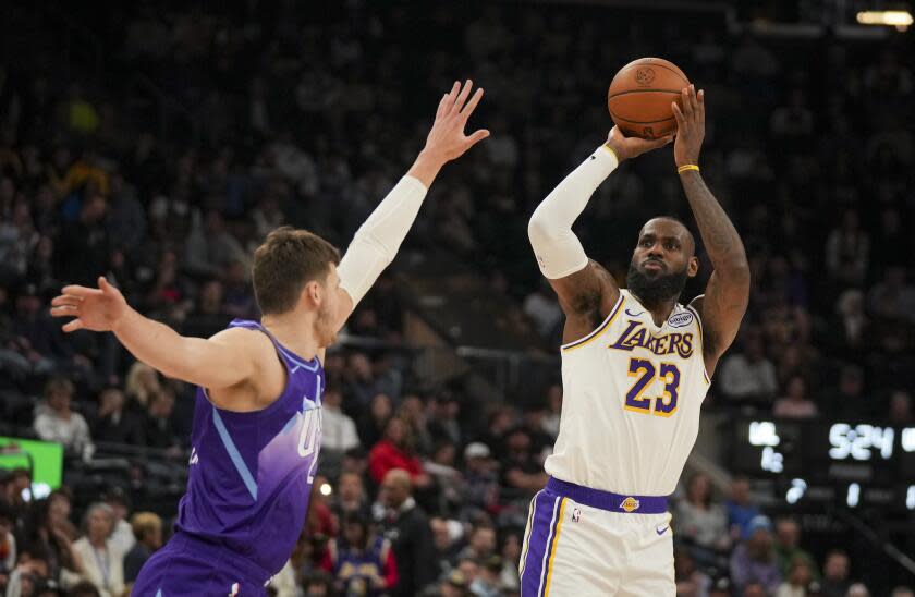 Los Angeles Lakers forward LeBron James (23) shoots the ball as Utah Jazz center Walker Kessler defends during the first half of an NBA basketball game, on Sunday, Dec. 1, 2024, in Salt Lake City. (AP Photo/Bethany Baker)