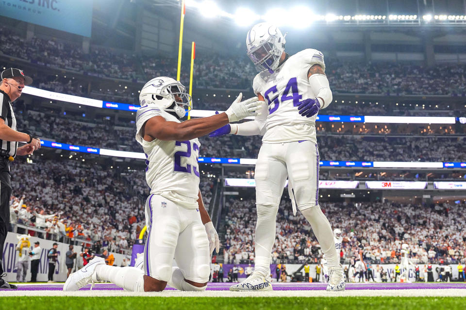 Dec 16, 2024; Minneapolis, Minnesota, USA; Minnesota Vikings cornerback Fabian Moreau (23) and linebacker Kamu Grugier-Hill (54) celebrate a play against the Chicago Bears in the fourth quarter at U.S. Bank Stadium. Mandatory Credit: Brad Rempel-Imagn Images