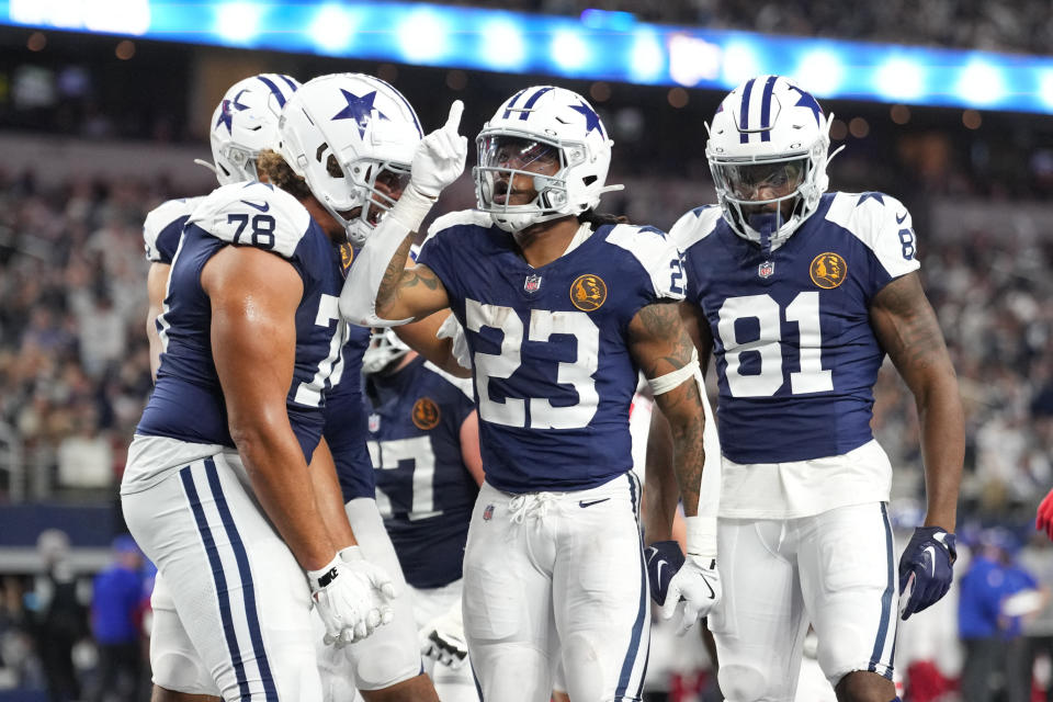 Nov 28, 2024; Arlington, Texas, USA; Dallas Cowboys running back Rico Dowdle (23) celebrates with teammates after scoring a touchdown against the New York Giants during the second half at AT&T Stadium. Mandatory Credit: Chris Jones-Imagn Images